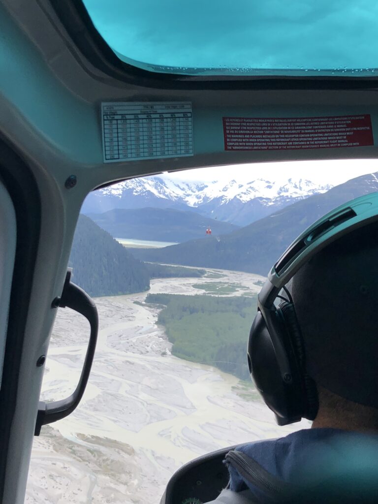 Photo of the Alaskan glacier through the window of a helicopter,