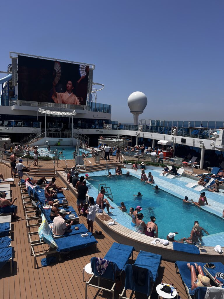 People having fun around a cruise ship swimming. pool